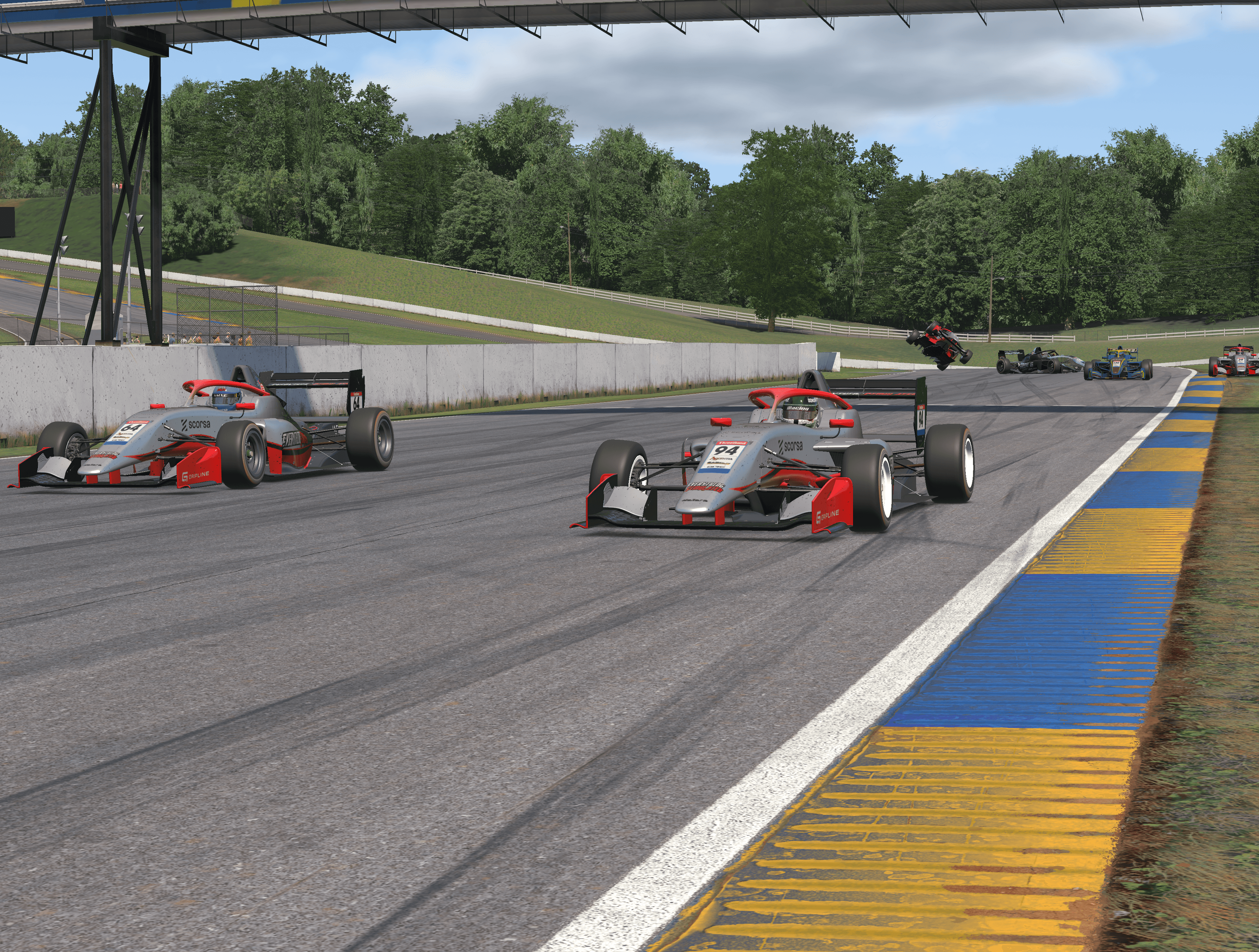 Scorsa-liveried open-wheel cars racing in iRacing